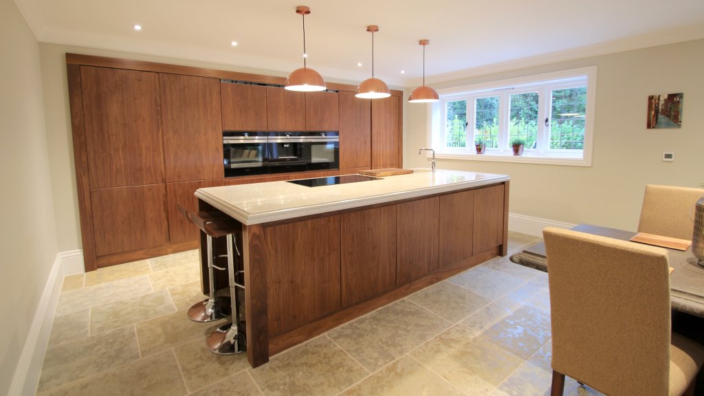 Walnut bespoke handleless kitchen with quartz worktop and Siemens appliances
