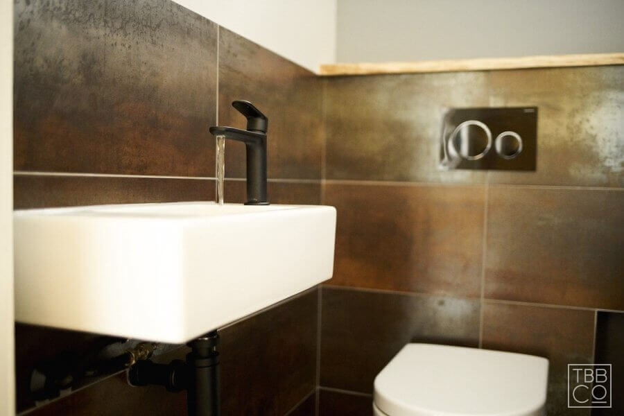 The Brighton Bathroom Company - Bronze main bathroom with floating oak shelves