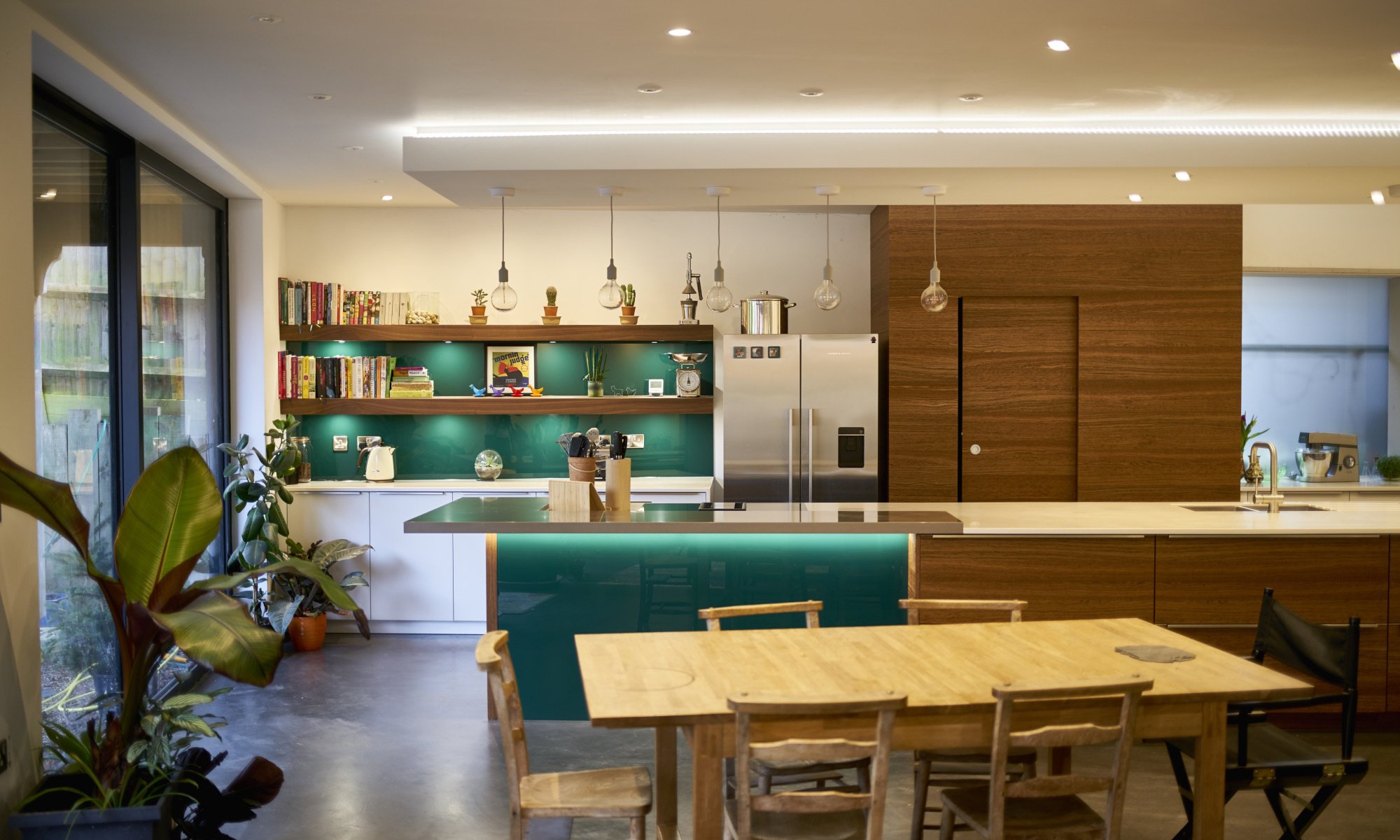 Stylish, contemporary kitchen with green glass accents