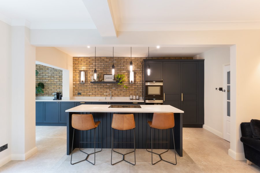 Painted Shaker kitchen in off black with leather stools